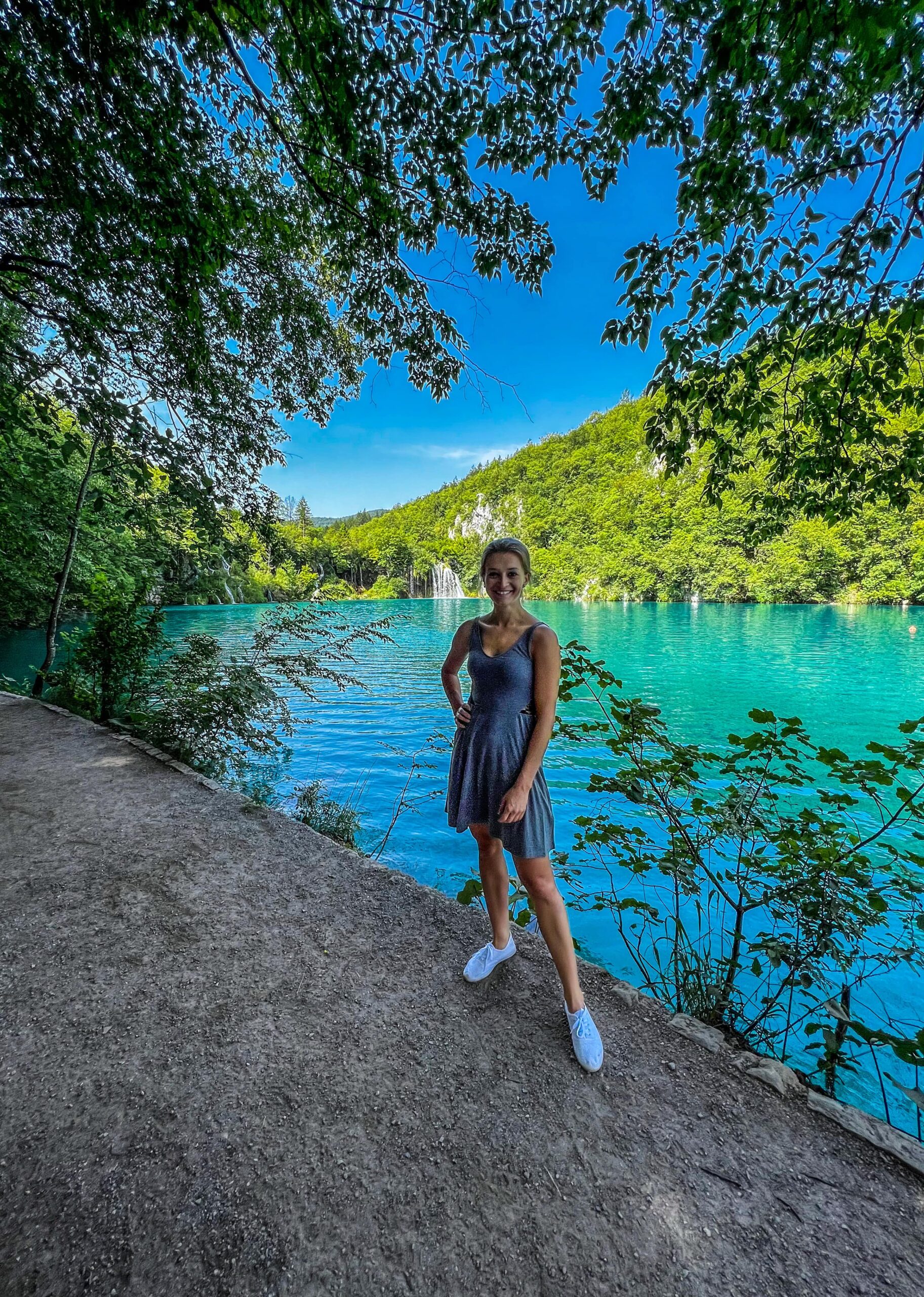 a_blonde_girl_standing_in_front_of_one_lake_in_croatia